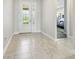 Bright foyer featuring ceramic tile flooring leading to an entry door with glass panels at 1839 Via Lago Dr, Lakeland, FL 33810