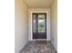 Inviting entryway featuring a decorative front door with glass panels and a brick paver landing at 1839 Via Lago Dr, Lakeland, FL 33810
