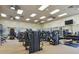Bright community gym featuring modern exercise equipment, mirrored walls, ceiling fans, and ample natural light at 1839 Via Lago Dr, Lakeland, FL 33810
