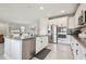 Kitchen featuring stainless appliances, an island with seating, and white cabinets and granite countertops at 1839 Via Lago Dr, Lakeland, FL 33810