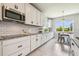 Kitchen with a breakfast nook, stainless steel appliances, white cabinets, and granite countertops at 1839 Via Lago Dr, Lakeland, FL 33810
