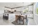 Bright eat-in kitchen with white cabinets, stainless steel appliances, granite counters, and tile backsplash at 1839 Via Lago Dr, Lakeland, FL 33810