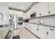 Kitchen boasting white cabinets, stainless steel appliances, and granite countertops with a tile backsplash at 1839 Via Lago Dr, Lakeland, FL 33810