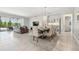 Open-concept living room with tile floors, a leather sofa, and glass sliding doors to the pool at 1839 Via Lago Dr, Lakeland, FL 33810
