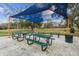 Community picnic area featuring multiple picnic tables and a shaded canopy for outdoor gatherings at 1839 Via Lago Dr, Lakeland, FL 33810