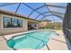 Inviting pool area enclosed by a screen, alongside covered patio area for lounging at 1839 Via Lago Dr, Lakeland, FL 33810
