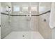 Glass enclosed shower featuring tile surround, a showerhead, and a built-in soap shelf at 1839 Via Lago Dr, Lakeland, FL 33810
