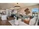 Open-concept living area featuring a stylish sofa, modern decor, and seamless flow to the dining area at 3762 King Hill Dr, Haines City, FL 33844