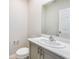Modern powder room featuring quartz countertops and gray cabinetry at 3782 King Hill Dr, Haines City, FL 33844