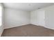 This bedroom features neutral-colored walls and carpet and a white door at 3782 King Hill Dr, Haines City, FL 33844