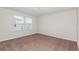 This bedroom offers natural light with two windows and neutral-colored carpet at 3782 King Hill Dr, Haines City, FL 33844