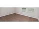This bedroom has neutral-colored carpet and walls with two windows bringing in sunlight at 3782 King Hill Dr, Haines City, FL 33844