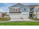 Charming townhome featuring a two-car garage and modern exterior design at 3782 King Hill Dr, Haines City, FL 33844