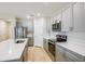 Stylish kitchen with stainless appliances, quartz countertops, and modern cabinets at 3782 King Hill Dr, Haines City, FL 33844