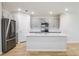 Modern kitchen featuring gray cabinetry, stainless appliances, and hardwood floors at 3782 King Hill Dr, Haines City, FL 33844