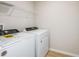 This laundry room includes a washing machine and dryer with wood-look flooring at 3782 King Hill Dr, Haines City, FL 33844