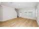 Spacious living room with hardwood floors, access to stairs, and natural light at 3782 King Hill Dr, Haines City, FL 33844