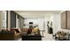 Stylish living area with a brown sectional, black accents, and an open flow into the kitchen at 4828 Waltham Forest Dr, Davenport, FL 33837