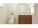 Bathroom showcasing a vanity with dark wood cabinets, a modern toilet, and decorative wall art at 5431 Lewisham Dr, Davenport, FL 33837