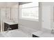 Bright bathroom with a soaking tub, dual vanities, and a large window providing natural light at 5431 Lewisham Dr, Davenport, FL 33837