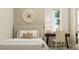Serene bedroom with neutral tones, a decorative wall piece, and a work desk at 5431 Lewisham Dr, Davenport, FL 33837