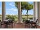 Inviting patio with black wrought iron furniture overlooking a lush green golf course and sunny blue skies at 5431 Lewisham Dr, Davenport, FL 33837