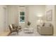 Cozy sitting room featuring neutral colors, comfortable seating, and a large window at 5431 Lewisham Dr, Davenport, FL 33837