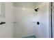 Modern bathroom features white textured tile, glass shelves, and a rainfall shower head at 211 W Crescent Dr, Lakeland, FL 33805