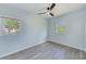 This bedroom offers gray vinyl flooring, fresh paint, updated fan, and large windows at 211 W Crescent Dr, Lakeland, FL 33805