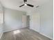 Bedroom features vinyl flooring, closet, fresh paint, and modern ceiling fan at 211 W Crescent Dr, Lakeland, FL 33805