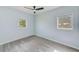 Bright bedroom with gray vinyl flooring, light blue walls, and two windows at 211 W Crescent Dr, Lakeland, FL 33805