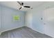 Freshly painted bedroom with vinyl flooring, modern fan, closet, and updated windows at 211 W Crescent Dr, Lakeland, FL 33805