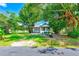 A charming single-Gathering home with mature trees, a carport, and a classic mailbox by the street at 211 W Crescent Dr, Lakeland, FL 33805