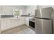 Modern kitchen with white cabinets, stainless steel appliances, and stylish backsplash at 211 W Crescent Dr, Lakeland, FL 33805