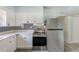 Well-equipped kitchen featuring stainless steel appliances, white cabinetry, and modern finishes at 211 W Crescent Dr, Lakeland, FL 33805