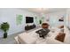 Staged living room featuring contemporary furnishings, wood floors, and abundant natural light at 211 W Crescent Dr, Lakeland, FL 33805