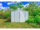 Durable metal storage shed nestled within the verdant backyard, providing secure storage space at 211 W Crescent Dr, Lakeland, FL 33805