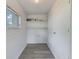A small utility room with vinyl flooring, window, and painted walls at 211 W Crescent Dr, Lakeland, FL 33805