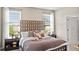 The main bedroom features a decorative headboard and large windows at 2437 Spring Tune Aly, Kissimmee, FL 34744