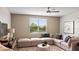 Cozy living room with sectional sofa and window views at 2437 Spring Tune Aly, Kissimmee, FL 34744