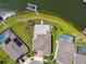 Overhead shot of home's backyard featuring a stone patio and fenced yard near a dock at 4950 Chase Ct, St Cloud, FL 34772