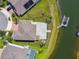 A bird's-eye view of a home's backyard, with a stone patio, fenced yard, and waterfront dock at 4950 Chase Ct, St Cloud, FL 34772