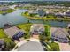 A scenic aerial view of a residential community surrounding a serene lake with private docks at 4950 Chase Ct, St Cloud, FL 34772