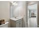 Powder room with a single-sink vanity and mirror, next to a hallway leading to the pool at 4950 Chase Ct, St Cloud, FL 34772
