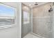 Bright bathroom featuring glass shower door and tiled walls at 4950 Chase Ct, St Cloud, FL 34772