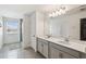 Bathroom displaying shower and double vanity with gray tile floor at 4950 Chase Ct, St Cloud, FL 34772