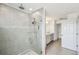 Bathroom showcasing the tiled shower, gray tile floors and double vanity at 4950 Chase Ct, St Cloud, FL 34772