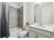 Bathroom with a shower-tub combo, neutral tile surround, and a single sink vanity at 4950 Chase Ct, St Cloud, FL 34772