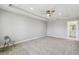 Spacious carpeted main bedroom featuring a ceiling fan and a tray ceiling at 4950 Chase Ct, St Cloud, FL 34772