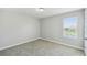 Empty bedroom featuring neutral carpet and a window at 4950 Chase Ct, St Cloud, FL 34772
